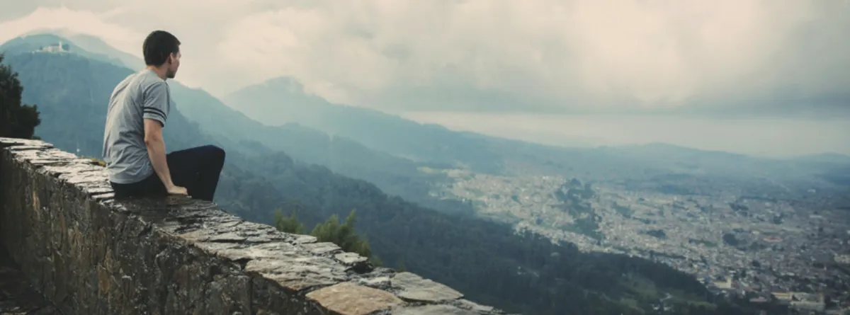 A man looking out over a city skyline