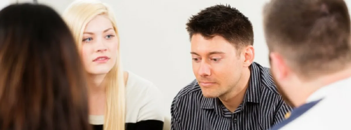Two men talking together in a supportive conversation