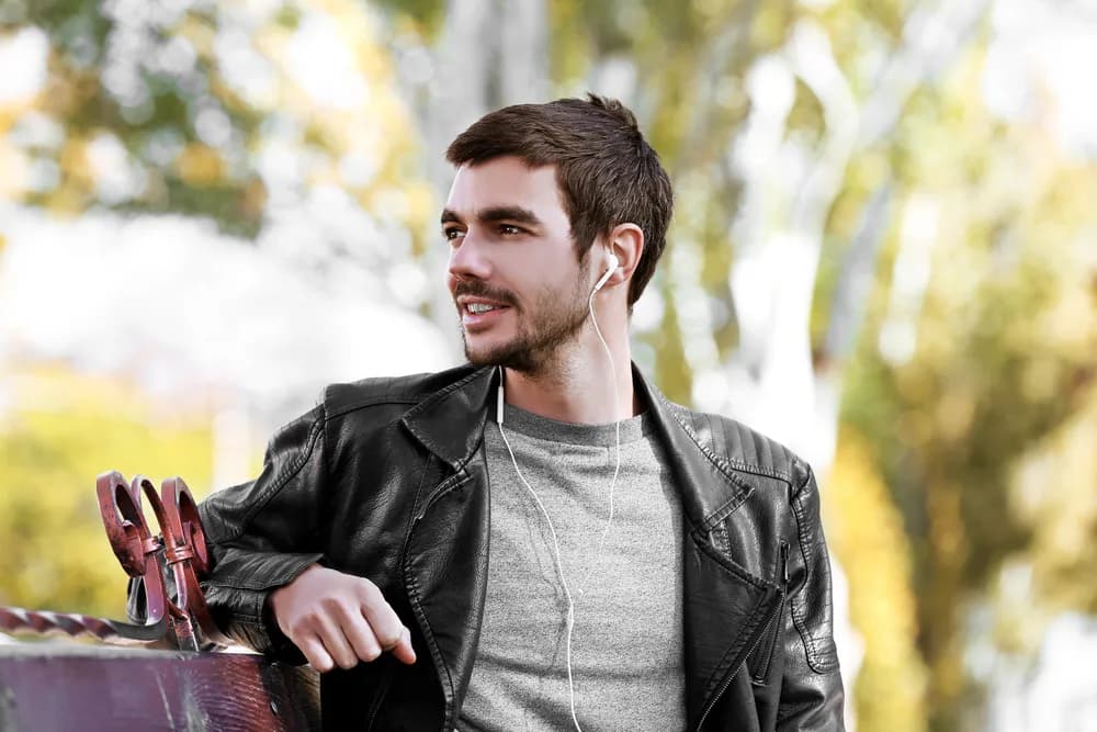 A young man smiling outdoors in soft afternoon light