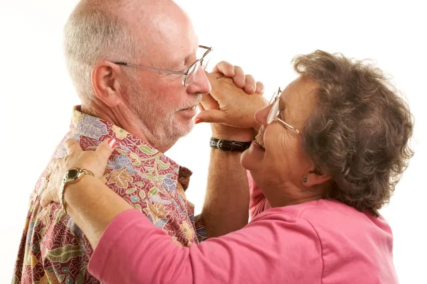 An older couple sharing a playful, affectionate moment
