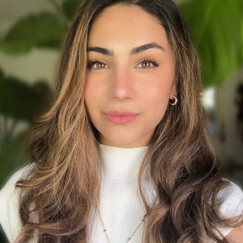 Katherine Garcia, Clinical Mental Health Counselor (CMHC) at Connections Counseling Services in Utah, smiling indoors with natural light and green plants in the background.