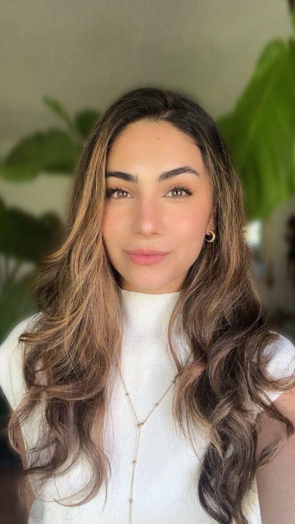 Katherine Garcia, Clinical Mental Health Counselor (CMHC) at Connections Counseling Services in Utah, smiling indoors with natural light and green plants in the background.
