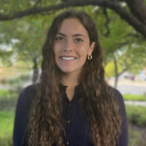 Lyndee Ledesma, Marriage and Family Therapist Intern at Connections Counseling, smiling outdoors under green trees.