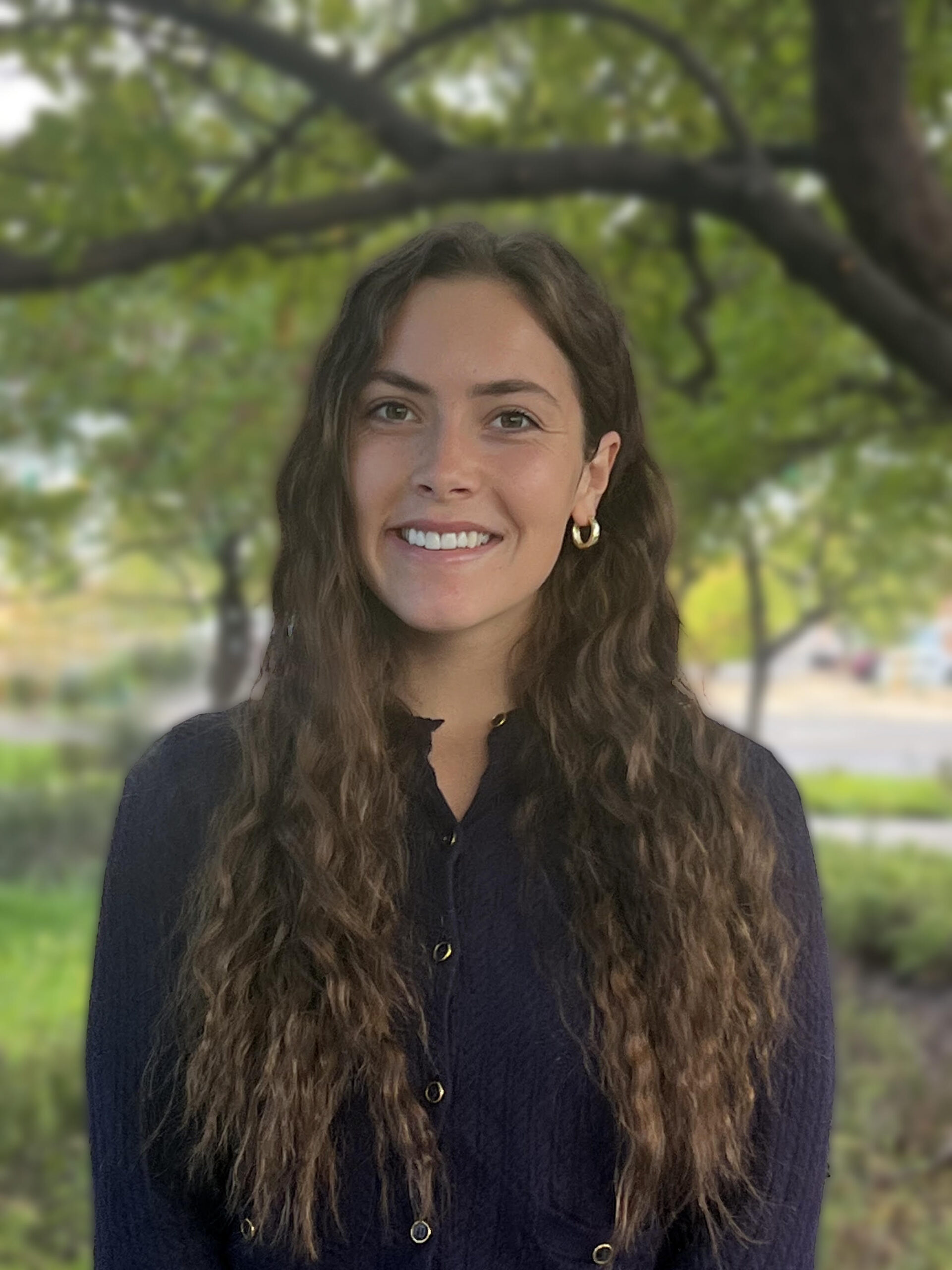 Lyndee Ledesma, Marriage and Family Therapist Intern at Connections Counseling, smiling outdoors under green trees.